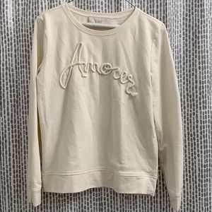 Cream colored crewneck sweatshirt